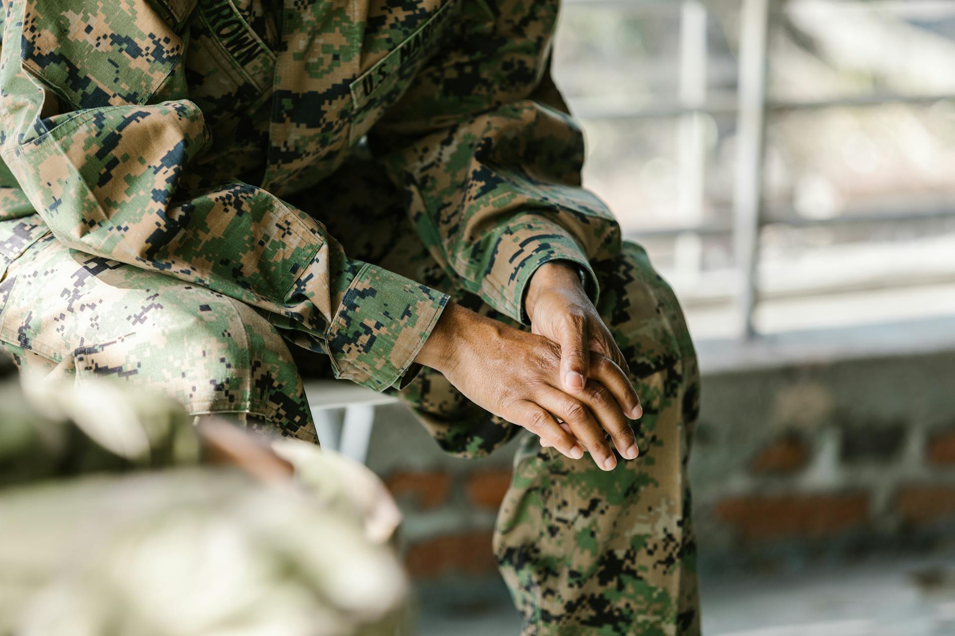 a close-up of a soldier's hands discussing his homelessness situation